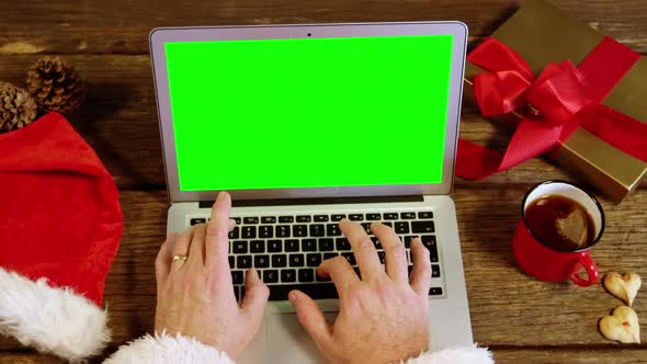 Santa claus using laptop alt