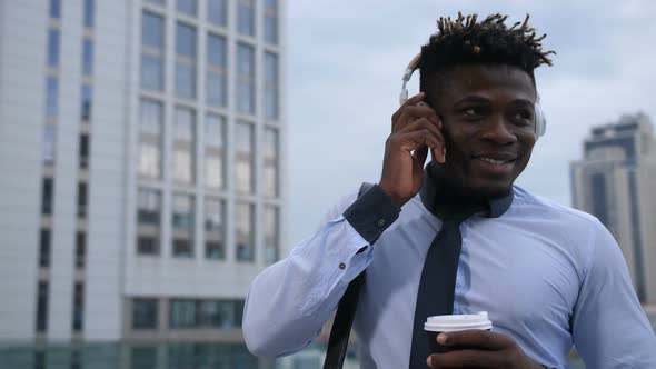 Cheerful Executive Having a Coffee Break on a Go alt