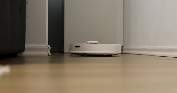 Robot cleaner cleans the room. Smart home. Robot vacuum cleaner performs automatic cleaning 