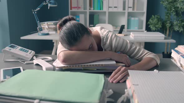 Exhausted office worker sleeping on the desk