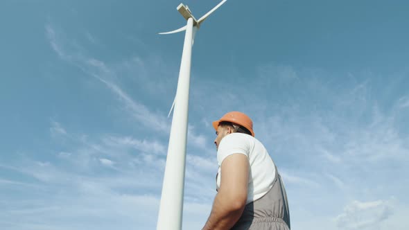 Competent Indian Technician Smiling Wind Turbines on Background alt