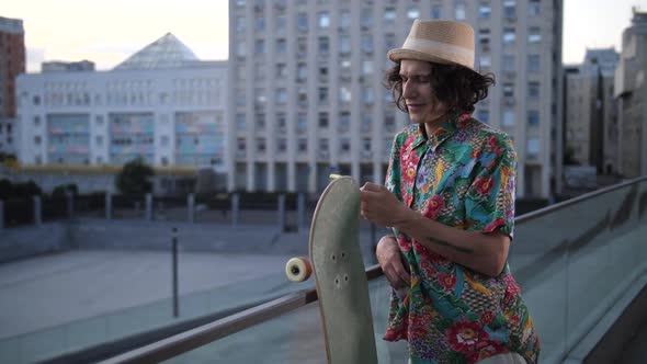 Skater Smiling While Networking on Phone Outdoor alt