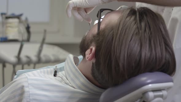 Dentist treats patient teeth