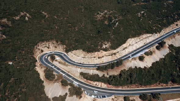 Aerial View of Serpentine Mountain Road with Cars Traffic alt