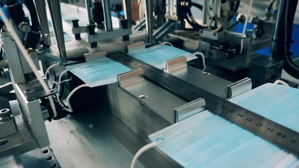 Face Masks Manufacturing Machine in Action. Close Up alt