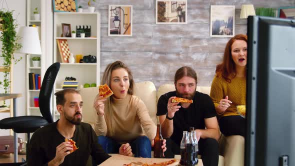 Revealing Shot of Close Friends Watching a Football Championship alt