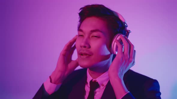 portrait studio rgb color concept yound smart asian businessman wear formal suit wear headphone