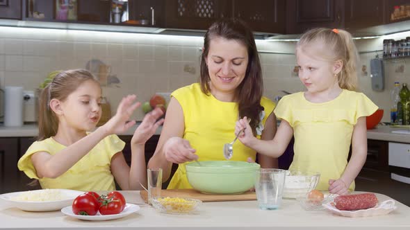 Close Up of a Cook Mixing Flour for Dough. A Child's Hand Pours Flour Into a Salad Bowl To Make alt