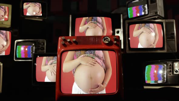 Pregnant Woman Holding Her Big Belly Standing against a Red Wall on Retro TVs.