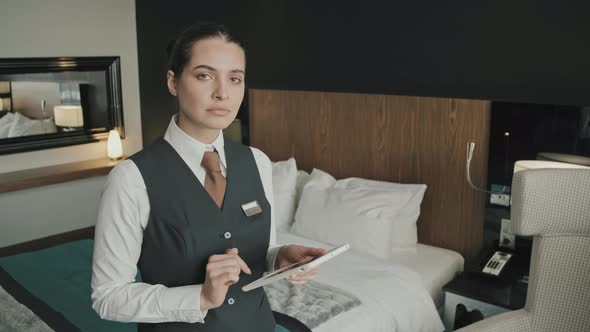 Female Hotel Manager with Tablet in Hotel Room alt