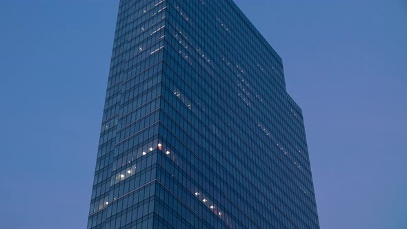 Time Lapse Day to Night Transition Blinking Office Windows Lights in Business Center Building alt