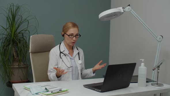 Female Medical Doctor Working Remotely Applying Telemedicine Indoors alt