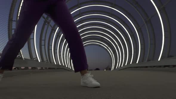 Shot of Legs of Talented Female Dancer Doing Some Dance Moves By Open Tunnel alt