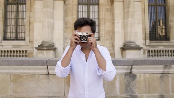 Handsome Freelancer in White Shirt Taking a Picture of Paris Architecture
