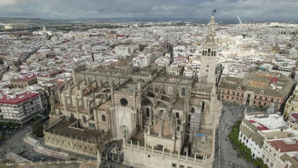 Grand Seville Cathedral with distinctive Gothic architecture; aerial