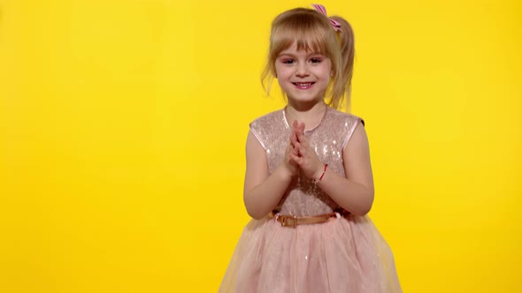Little Blonde Child Girl 5-6 Years Old Smiling, Dancing, Celebrating on Yellow Studio Background alt