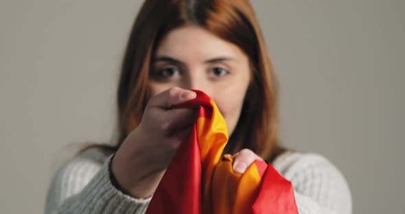 Ukrainian Girl Holding a Multi Color Peace Flag alt