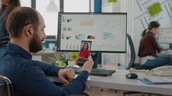 Disabled Paralyzed Invalid Man Holding Smartphone Talking on Webcam alt