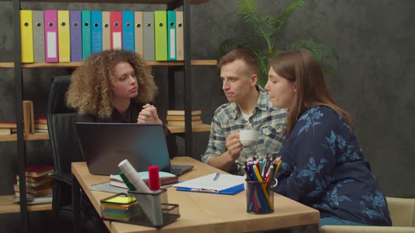 Couple of Potential Buyers and Woman Realtor Choosing Property on Laptop Pc alt