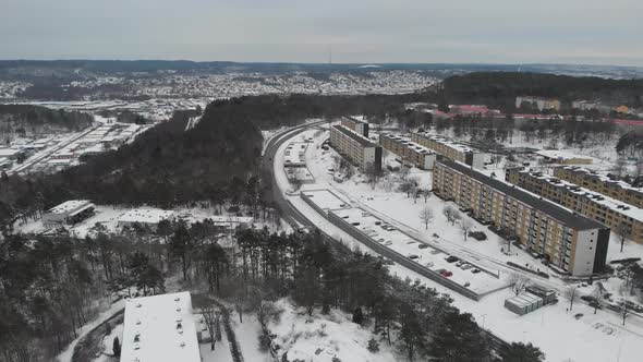 Apartment Buildings on a Hill Winter Time Aerial Reveal alt