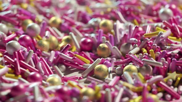 Closeup animation of colorful sugar sprinkles stacked in an endless loop. 4K HD