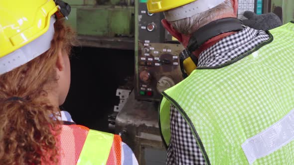 Group of Factory Workers Using Machine Equipment in Factory Workshop alt