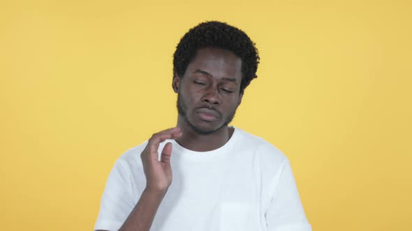 African Man with Neck Pain Yellow Background alt