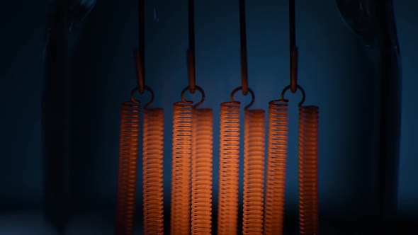 Electric Vintage Edison Light Bulb with a Spiral Flashing on a Blue Background alt