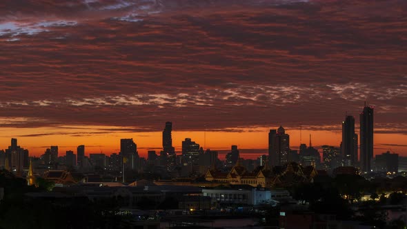 Dramatic sun rises over Bangkok downtown city center with Grand Palace - Time lapse