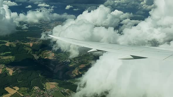 View on the Airplane wing from inside the plane while flying over Germany