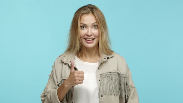 Close Up of Enthusiastic Blond Woman Approve Something Cool Showing Thumbs Up and Like Product Look