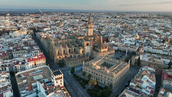 Flying Over Gothic Cathedral in Seville Old Town with Famous Giralda Bell Tower alt