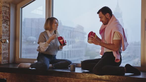 Man and Woman Eating Wok Noodles By the Window Overlooking the City alt