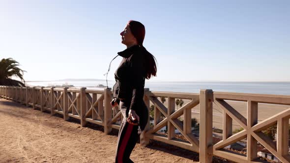 Mature Woman Exercising At The  Beach alt