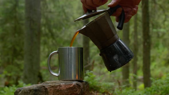 Coffee is Poured Into a Mug From a Coffee Maker alt