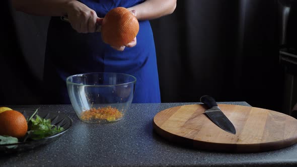 Woman removes grapefruit peel alt