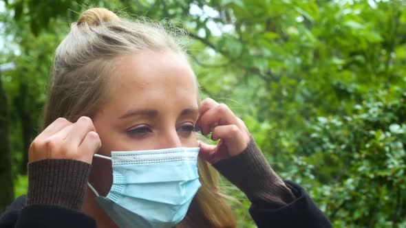 Beautiful Girl In A Summer Park Takes Off Her Mask