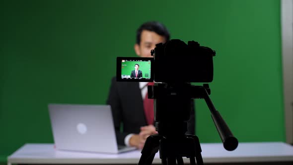Camera Record Professional Asian Male Anchor Reporting On Green Screen At Home Studio alt