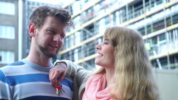 Couple On Front Of New House With Keys Ring alt