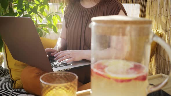 Faceless Woman Using Laptop on Summer Terrace