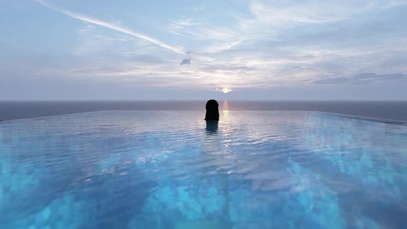 Woman Floating In The Pool At Sunset