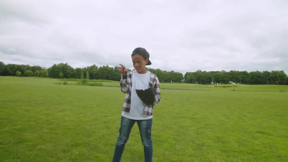 Portrait of Cute Little African Boy Pitcher Throwing Baseball Outdoors alt