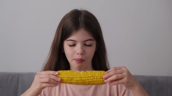Little Young Girl Eating Boiled Corn