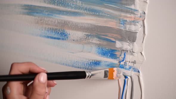 Young female artist draws abstract picture, pastel colours acrylic paint alt