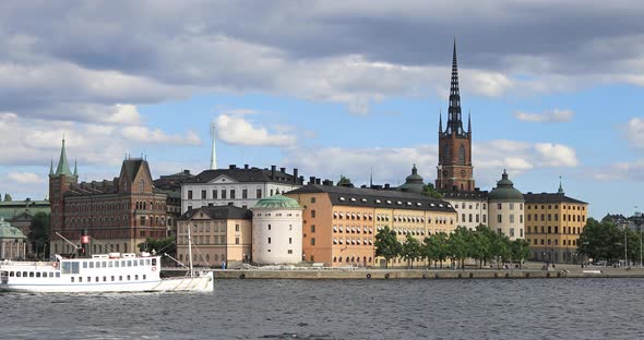 Passenger ship passes by buildings of Old Town in Stockholm