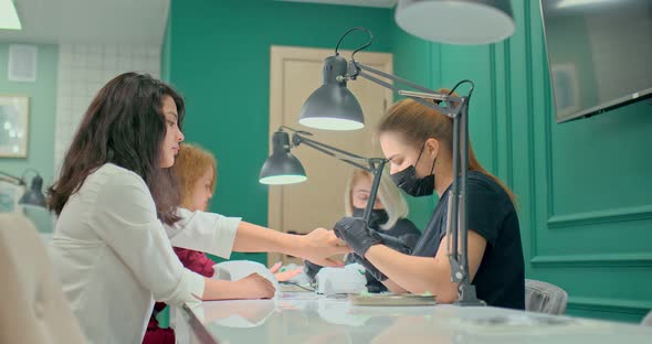 Professional Manicure Studio Beautiful Girls Masters Do Manicure to Clients alt