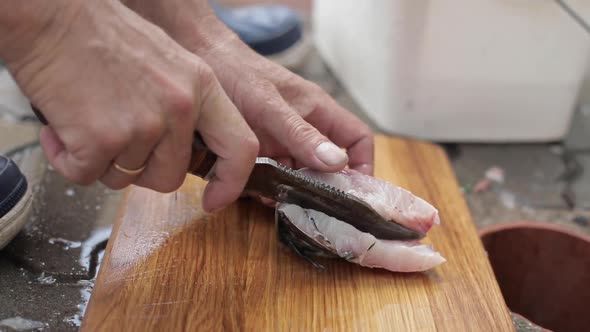 Men's Hands Cut and Clean the Fish Fresh Freshly Caught Fish