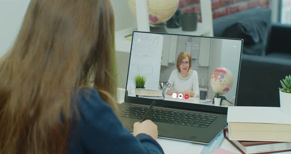 Teenager Girl Student Study Online Lesson with Teacher on Video Chat Using Laptop at Home alt