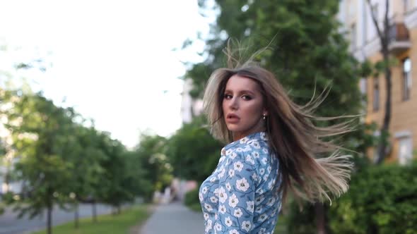 Gorgeous Woman in Dress Walking Towards Camera in the Street