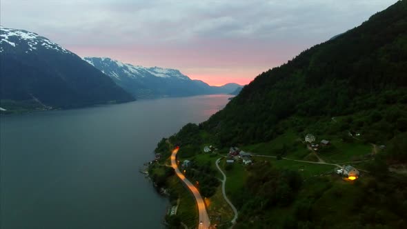 Flying over popular Hardanger fjord in Norway in the evening, aerial footage